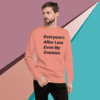A man wearing a sweater with the words " everyone 's after love even my enemies ".