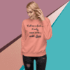 A woman wearing a peach colored sweatshirt with the words " call me a fool, i only want to be with jesus ".