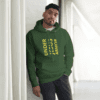 A man standing in front of a pillar wearing a green hoodie.