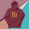 A maroon hoodie with the words under jesus armour on it.
