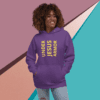 A woman wearing a purple hoodie with the words " under jesus armor ".