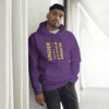 A man in purple hoodie standing next to white pillar.
