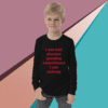A young boy wearing a long sleeve shirt with the words " i am not always gaming sometimes, i am asleep ".