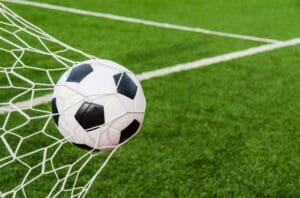 A football getting hit inside a net