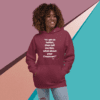 A woman is wearing a hoodie with an image of a person 's face.