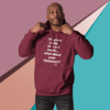 A man in a maroon hoodie with the words " if you can 't tell me it's ok to be, what about your grammar ?" on