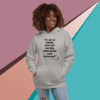 A woman is wearing a hoodie with a quote.