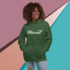 A woman wearing a green hoodie with the word blessed written on it.