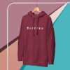 A maroon hoodie hanging on a wall.