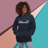 A woman wearing jeans and a hoodie with the word blessed written on it.