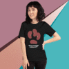 Woman wearing a black t-shirt with a unique abstract design and text.