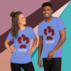Two people wearing matching blue t-shirts with a red puzzle piece design.
