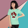 Woman wearing a mint green t-shirt with a unique red graphic design.