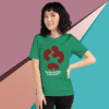 Person wearing a green T-shirt with a red abstract design and text.