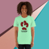 Smiling person wearing a mint green T-shirt with a creative abstract design.