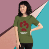 Woman wearing an olive green T-shirt with a red abstract design and text.