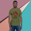 Man wearing green t-shirt with red graphic on colorful geometric background.