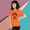 Woman wearing an orange T-shirt with a bold graphic design.