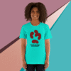 Smiling woman wearing a turquoise T-shirt with a red and black design.