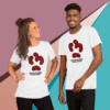 Two smiling people wearing matching white t-shirts with a creative logo.