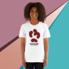 Smiling woman wearing a white t-shirt with a red abstract design and text.