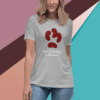 A gray t-shirt with a red paw print and the text 'Do the hokey pokey and turn yourself around'.