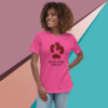 Smiling woman wearing a pink T-shirt with a unique design and text.