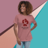 Smiling woman wearing a pink graphic tee with abstract shapes and text.