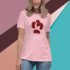 Woman wearing a pink shirt with a paw print and text design.
