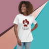 Smiling woman wearing a white T-shirt with a red paw print and text design.