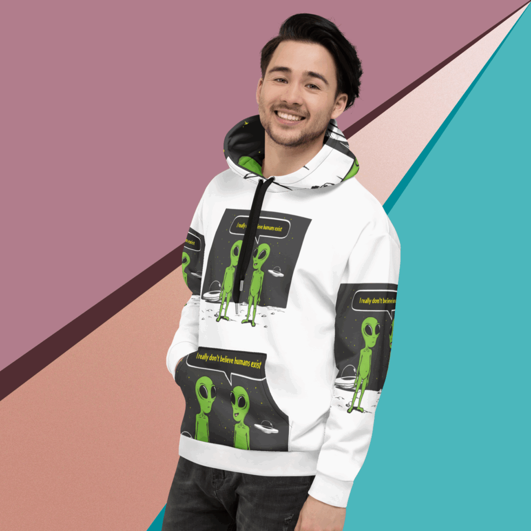 A man smiling wearing a white hoodie with green and black design.