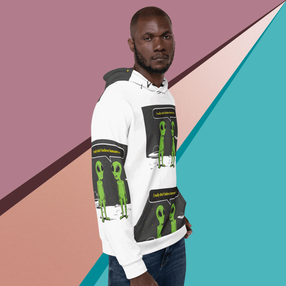 Man wearing a graphic white hoodie against a geometric colorful background.