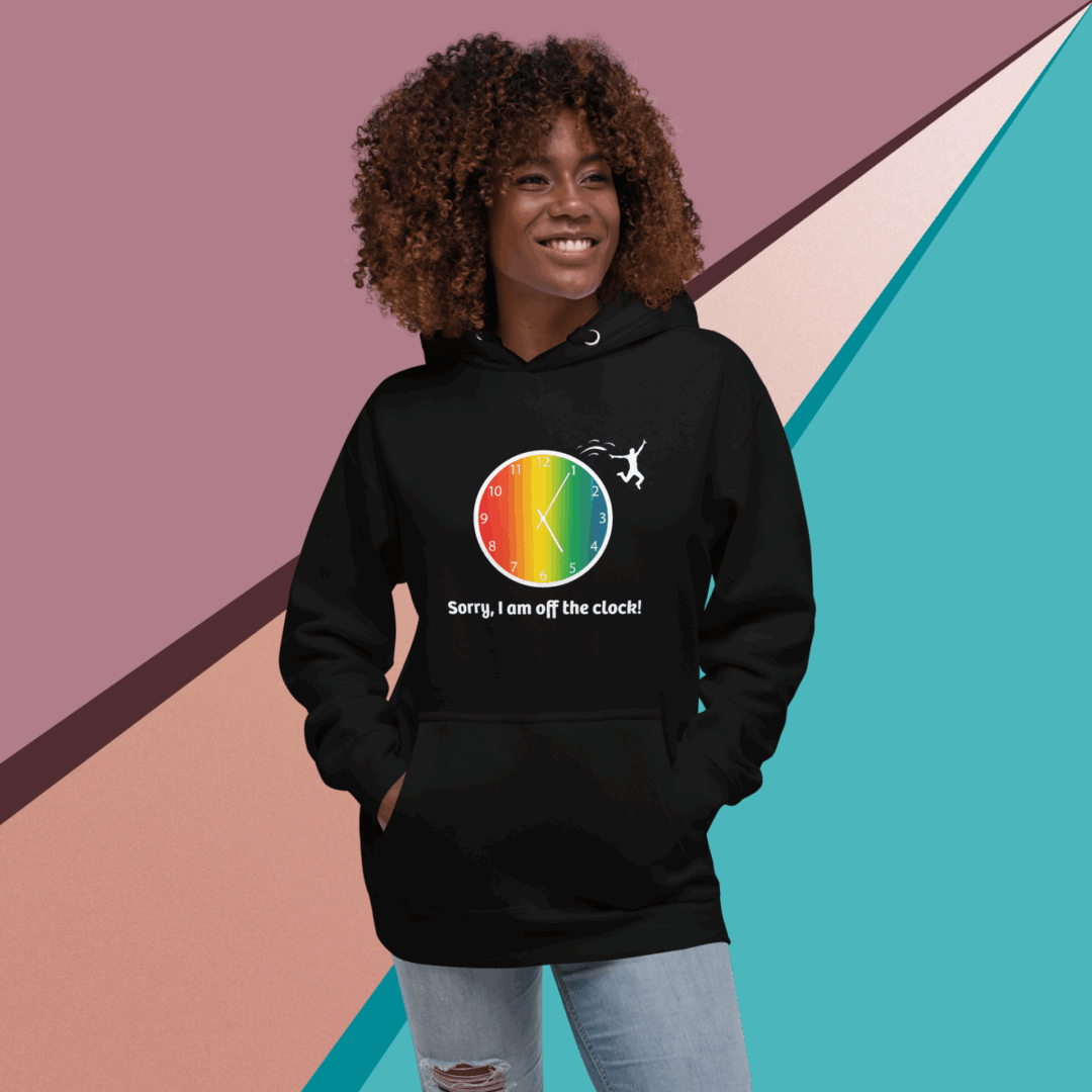 Smiling woman in a black hoodie with a colorful circular design.