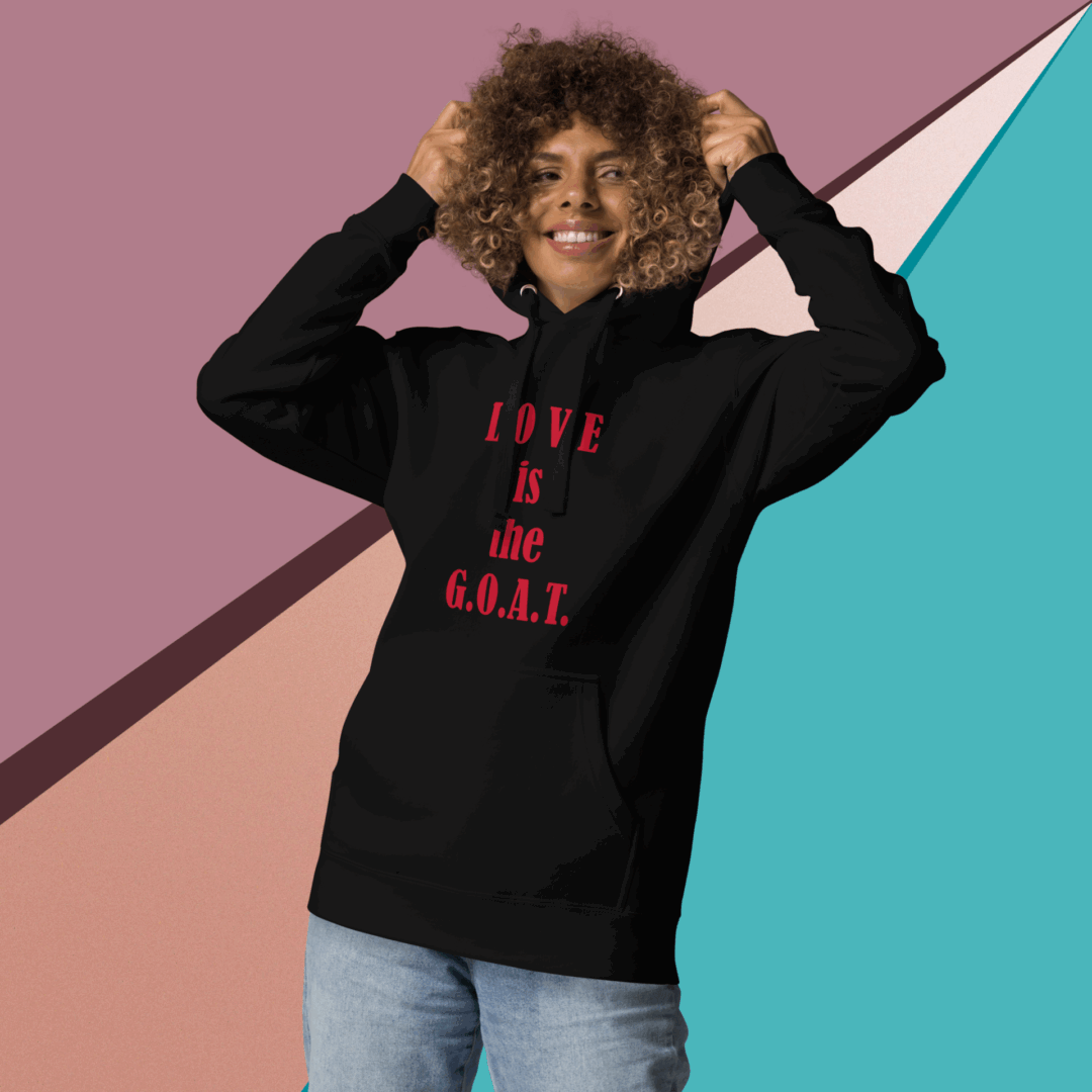 Person wearing a black hoodie with red text, posing against a colorful geometric background.