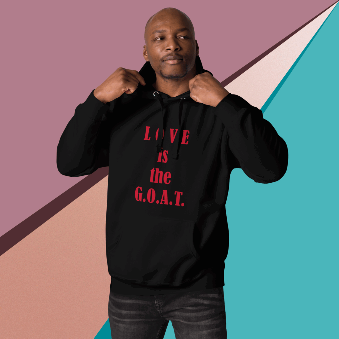 Man wearing a black hoodie with the phrase 'LOVE is the G.O.A.T.'