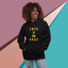 Smiling person wearing a black hoodie with 'LOVE is the G.O.A.T.' text.