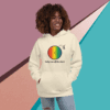 cotton-heritage-m2580-i-unisex-premium-pullover-hoodie-bone-front-68e3235983586 Smiling woman wearing a colorful graphic hoodie with rainbow and text.