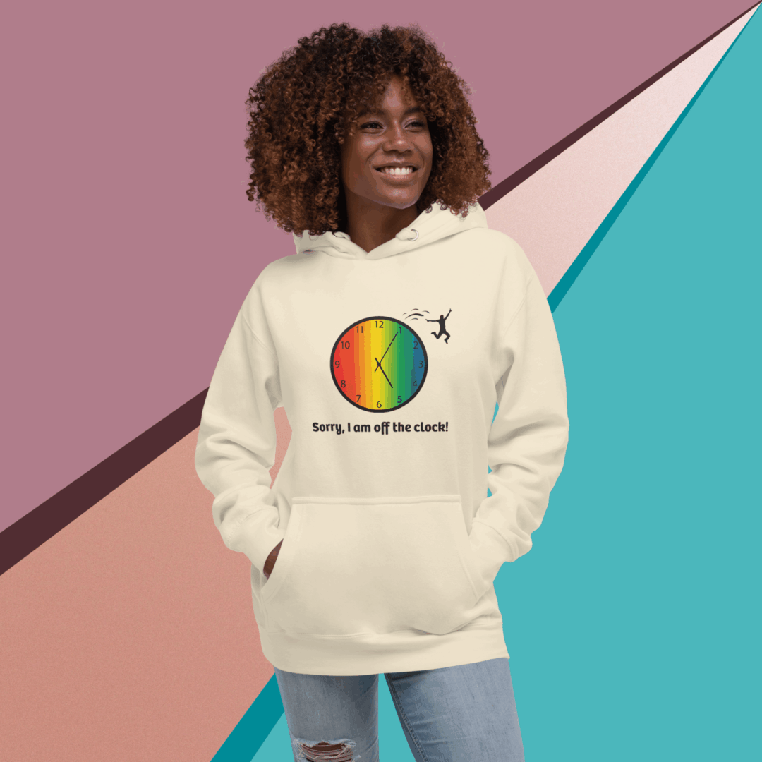 cotton-heritage-m2580-i-unisex-premium-pullover-hoodie-bone-front-68e3235983586 Smiling woman wearing a colorful graphic hoodie with rainbow and text.