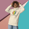 cotton-heritage-m2580-i-unisex-premium-pullover-hoodie-bone-front-68e3254333130 Smiling man in a colorful, artistic hoodie against a geometric background.