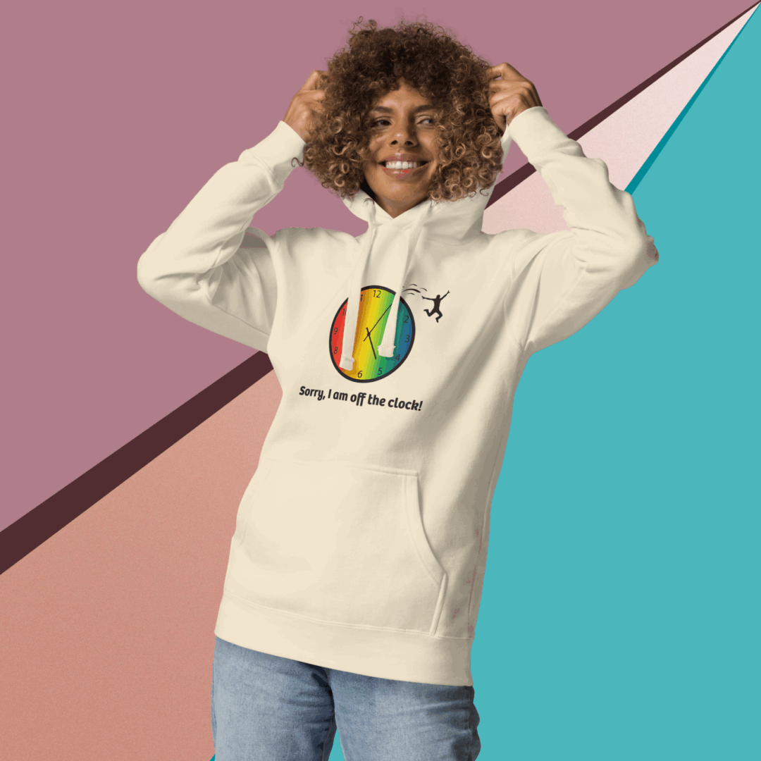 cotton-heritage-m2580-i-unisex-premium-pullover-hoodie-bone-front-68e3254333130 Smiling man in a colorful, artistic hoodie against a geometric background.