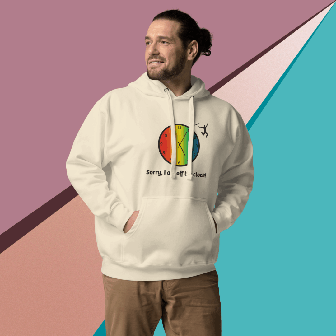 cotton-heritage-m2580-i-unisex-premium-pullover-hoodie-bone-front-68e326014e084 Man wearing a beige hoodie with a colorful circular design, smiling against a geometric background.