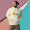 Man wearing a beige hoodie with colorful graphics against a geometric background.