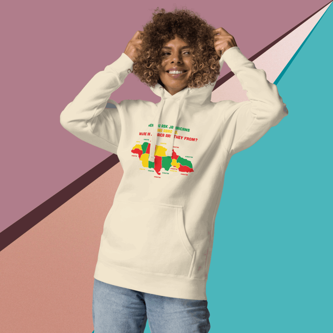 Smiling person wearing a beige hoodie with a colorful Africa design.