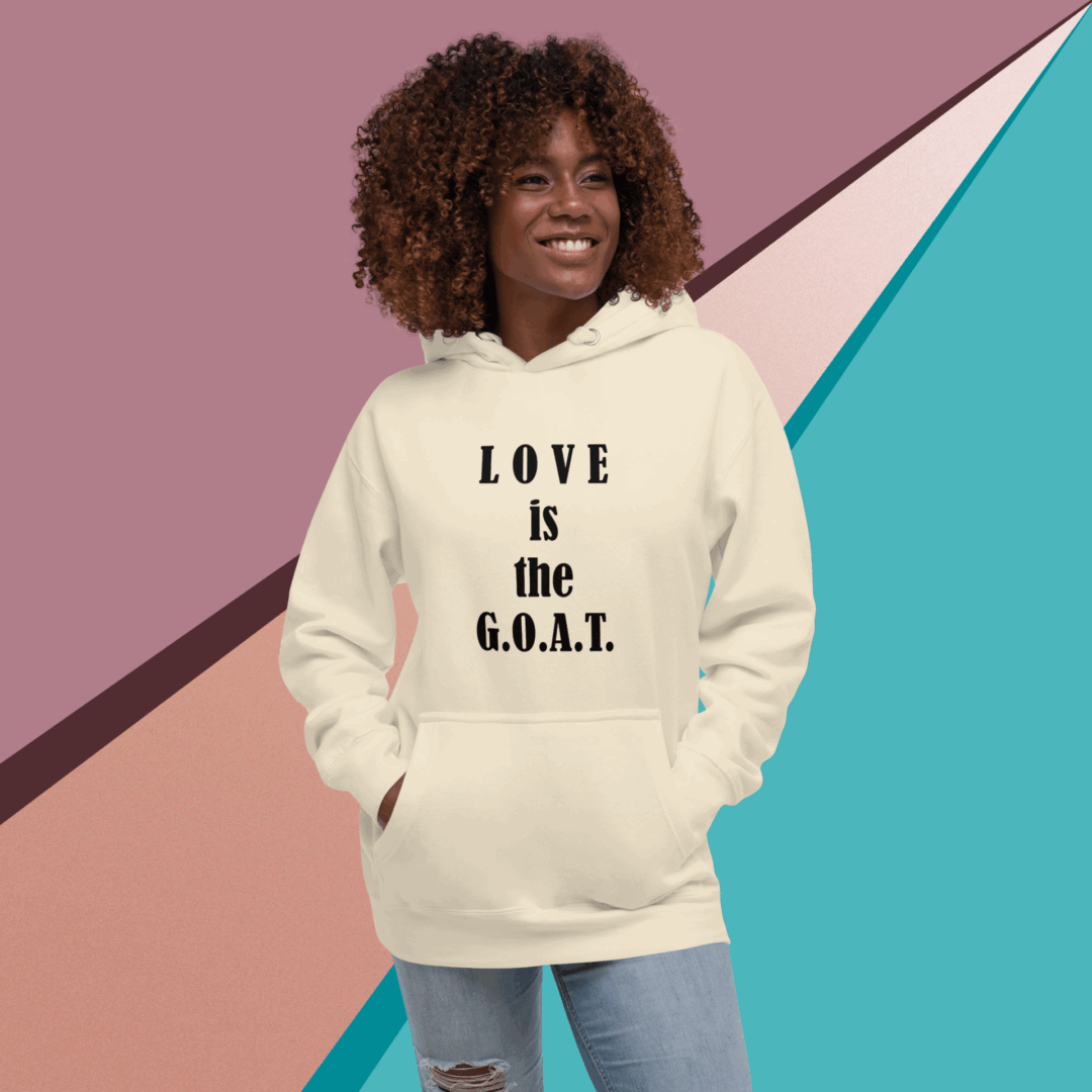 Smiling woman wearing a hoodie with 'LOVE is the G.O.A.T.' text.