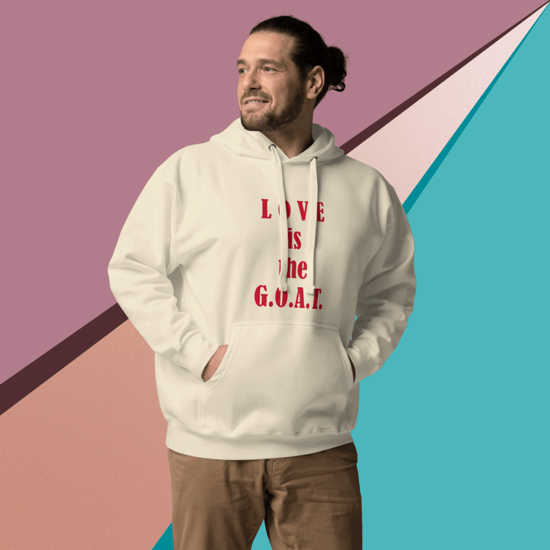 Man wearing a cream hoodie with red text against a colorful geometric background.
