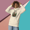 Smiling woman in a cream hoodie with graphic design and jeans.