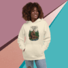 Smiling woman wearing a cream hoodie with a colorful graphic design.