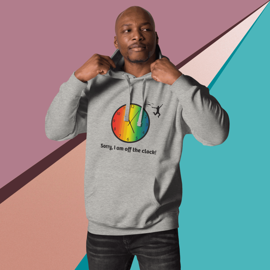 cotton-heritage-m2580-i-unisex-premium-pullover-hoodie-carbon-grey-front-68e3264680467 Man wearing a gray hoodie with a colorful graphic and text.