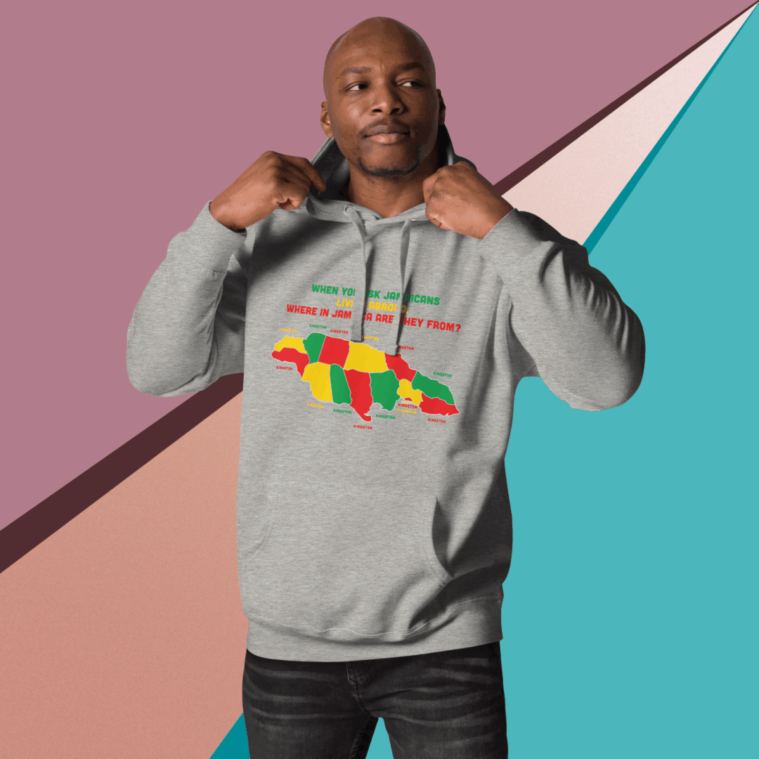 Man posing confidently in a gray hoodie with a colorful African continent design.