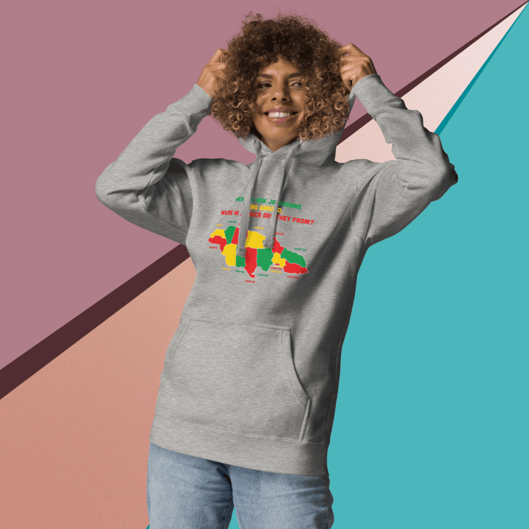 Smiling woman in a gray hoodie with colorful geometric design.